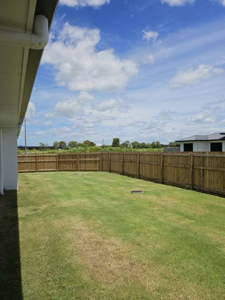 Tidy backyard lawn with crisp edges and a clean finish after mowing